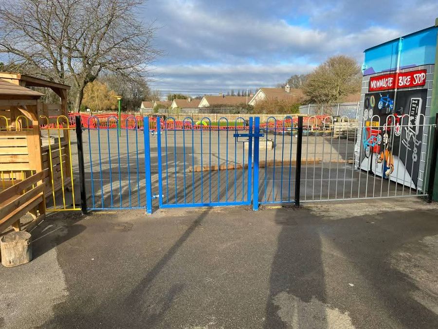 Bow-top gates and railings securing a school entrance